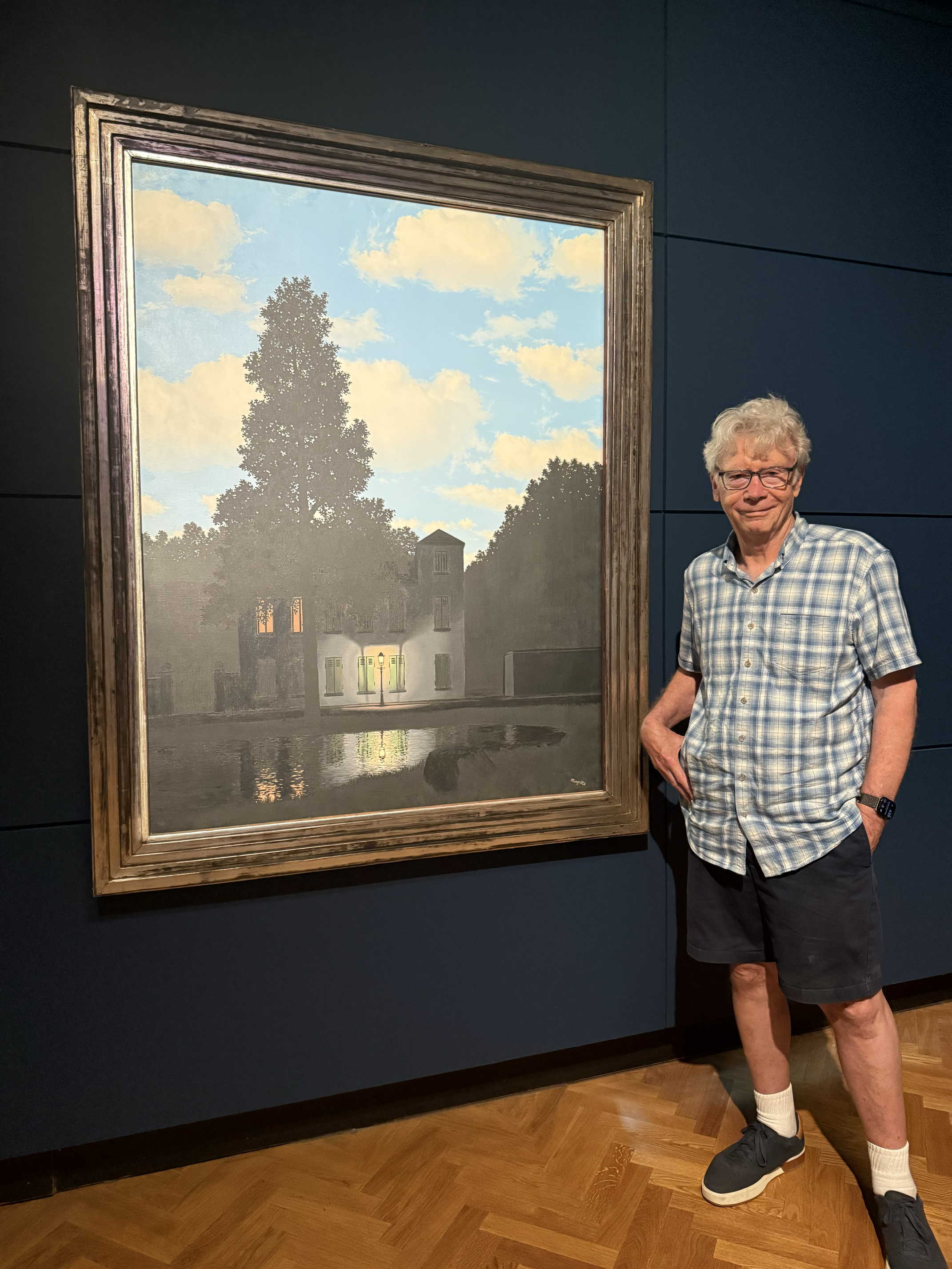 Author standing next to the Magritte painting in Brussels
